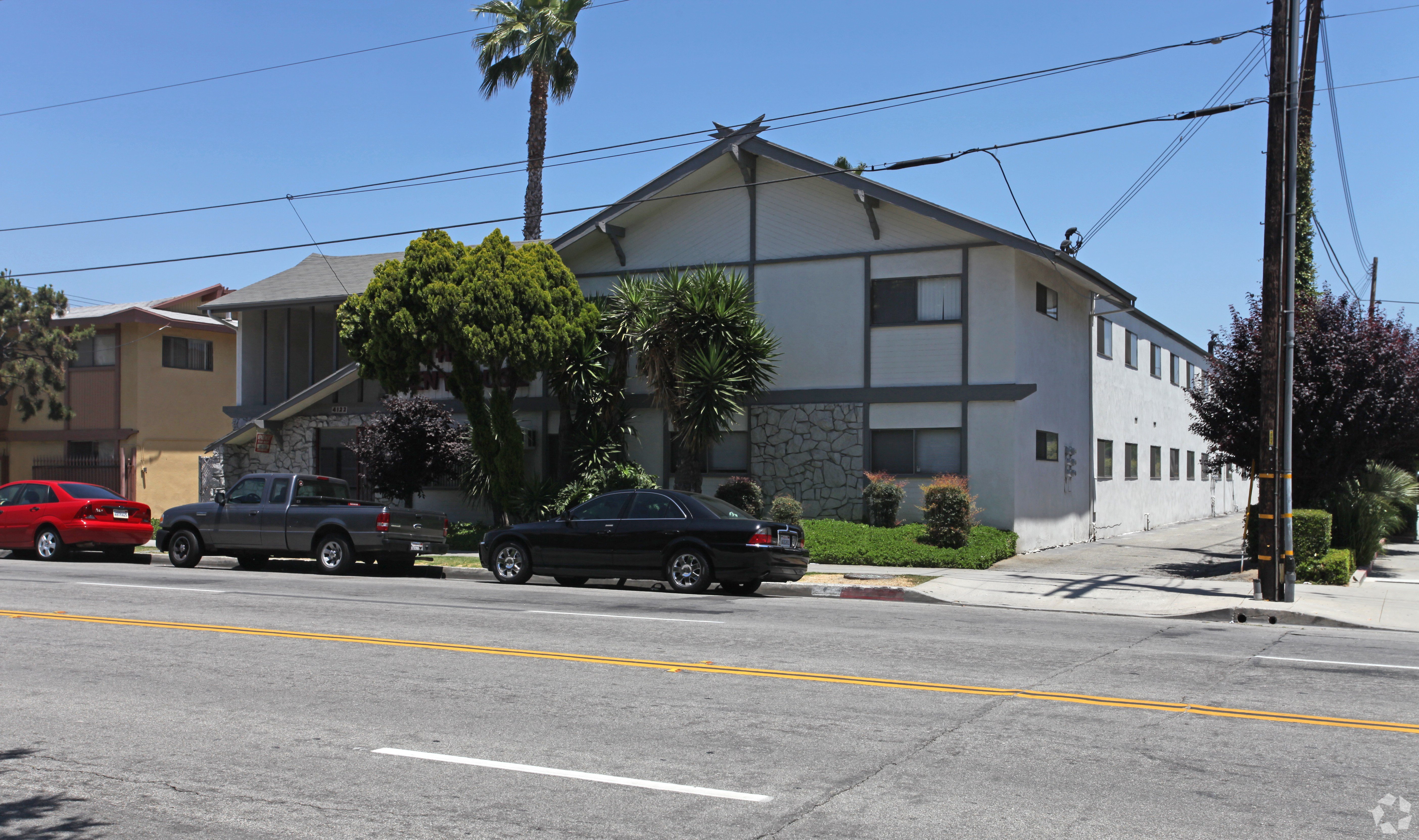 A black car is parked on the side of the road.
